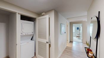 a laundry room with a washer and dryer and a hallway to a bathroom at Chase Knolls, Sherman Oaks, CA